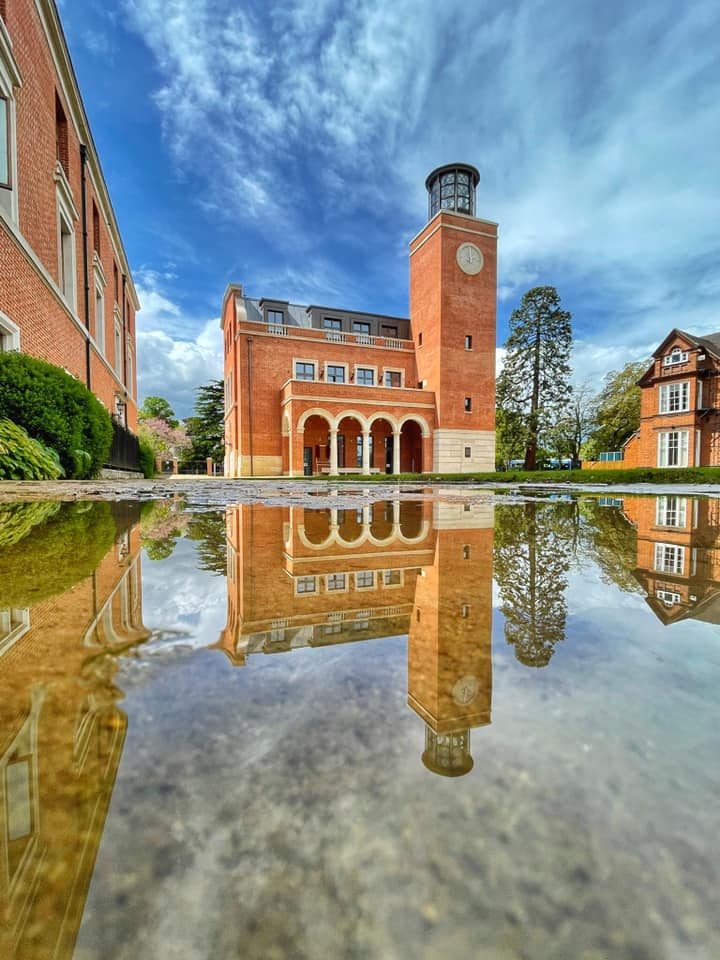 Image of the Bartlam Library and Ann's Court with the building reflected in a puddle (by and copyright Sir Cam)